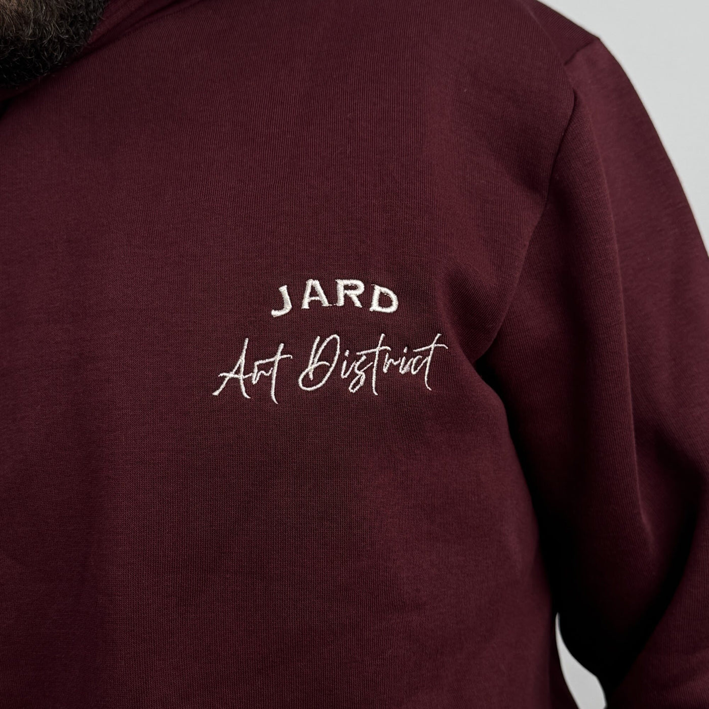 Art District Hoodie in Burgundy — chest embroidery detail