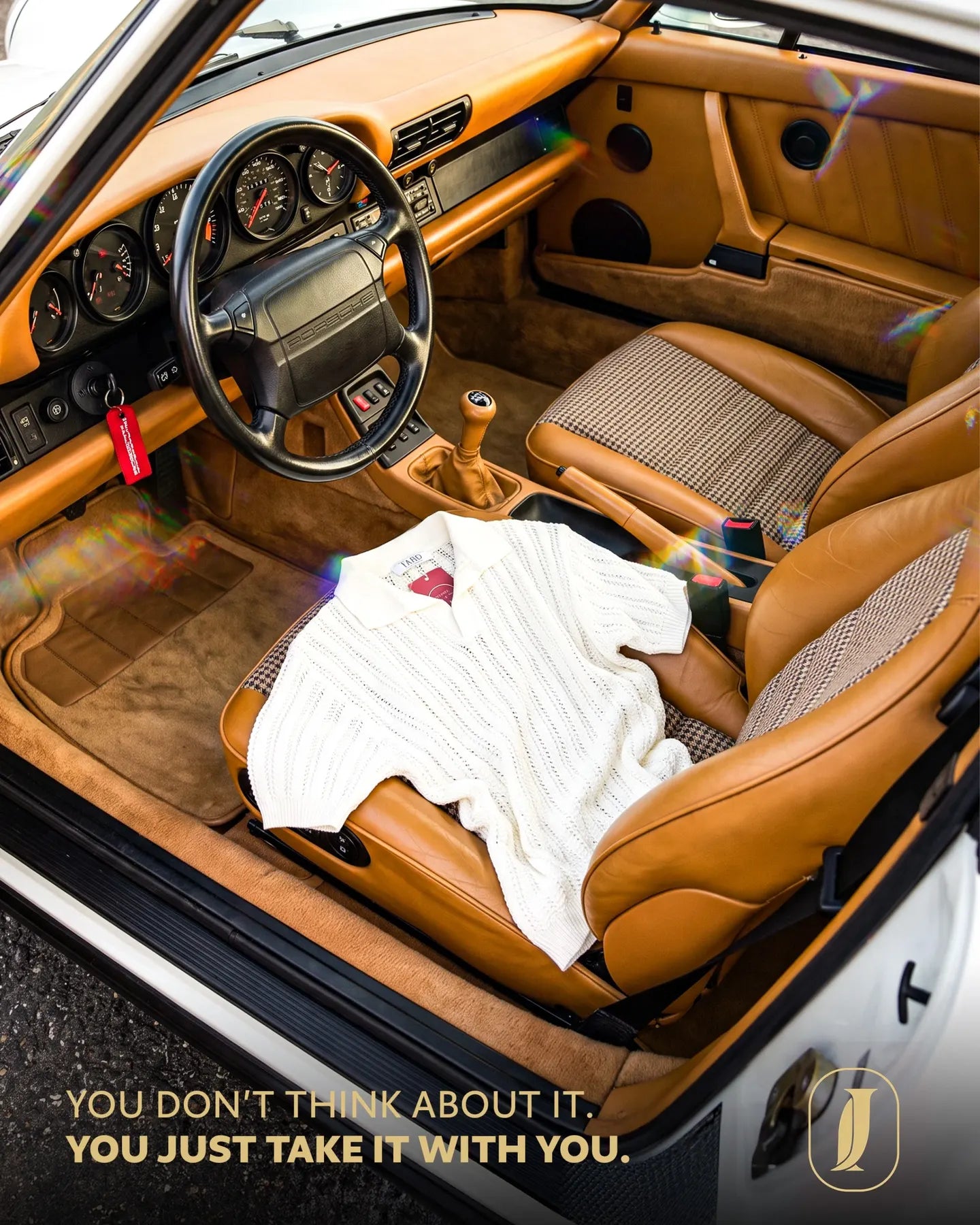 JARD white knitted polo styled inside a classic car